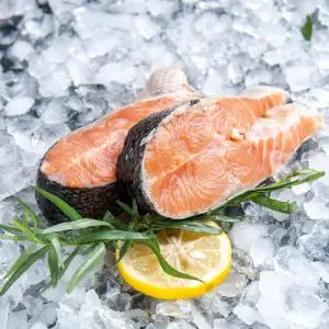 seafood and lemon surronded by ice